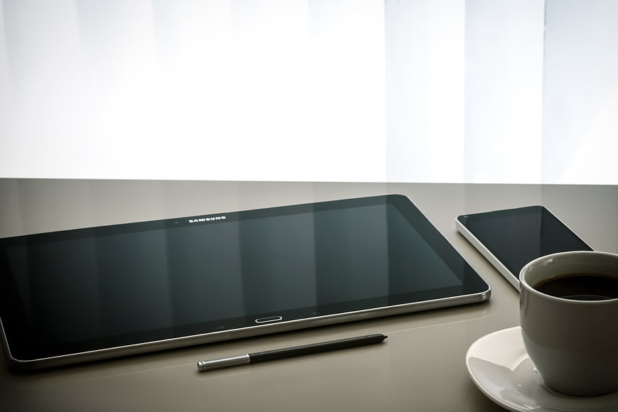 Modern tablet, smartphone, and coffee on a desk
