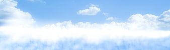 Bright Blue Sky with Fluffy White Clouds Background