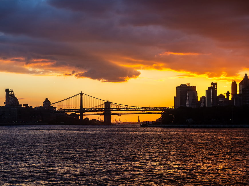 Dramatic Sunset Over Manhattan Bridge and New York City Skyline