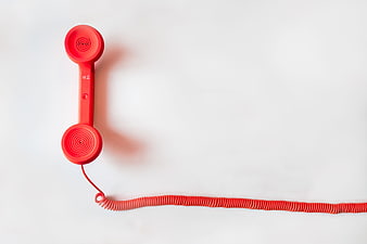 Red Corded Telephone Handset on White Background