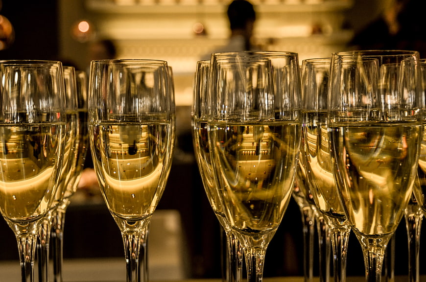 Close-up of champagne glasses with golden bubbly liquid