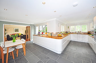Modern White Kitchen with Wooden Island and Dining Area
