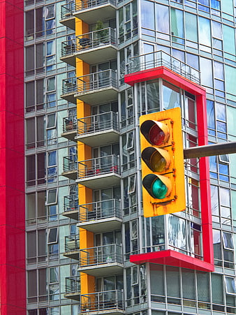 Colorful Urban Traffic Light Against Modern Apartment Building