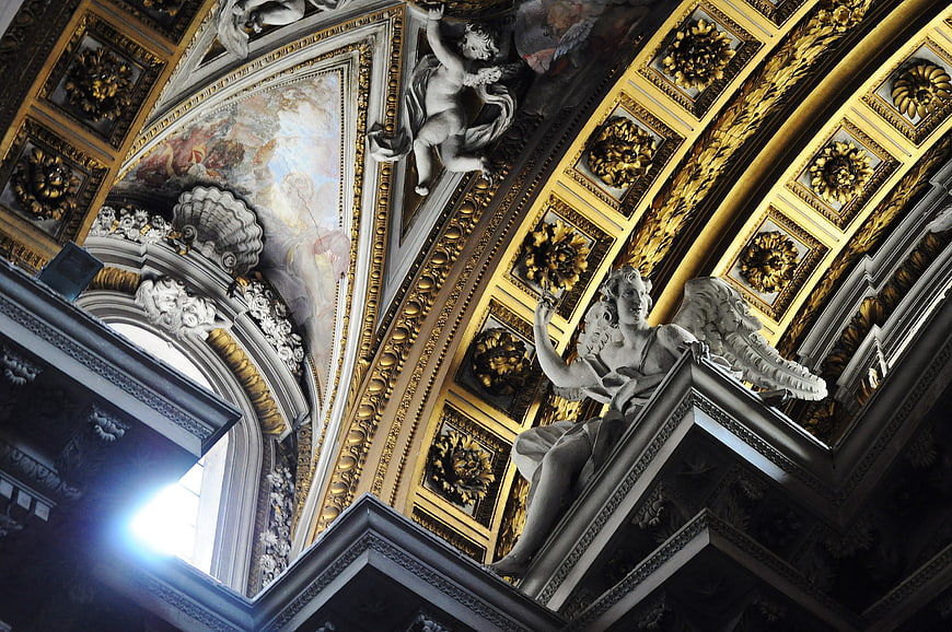 Baroque church ceiling with gold details and angel sculptures