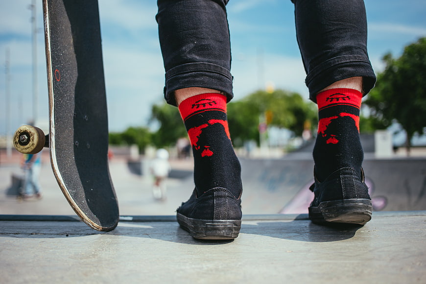 Skateboarder Feet with Red Socks at Skatepark