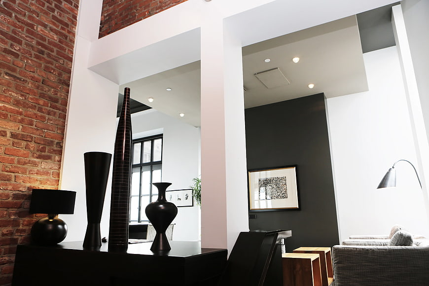 Modern Loft Interior with Black Ceramic Vases and Exposed Brick