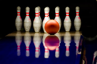 Orange Bowling Ball and Pins on Lane