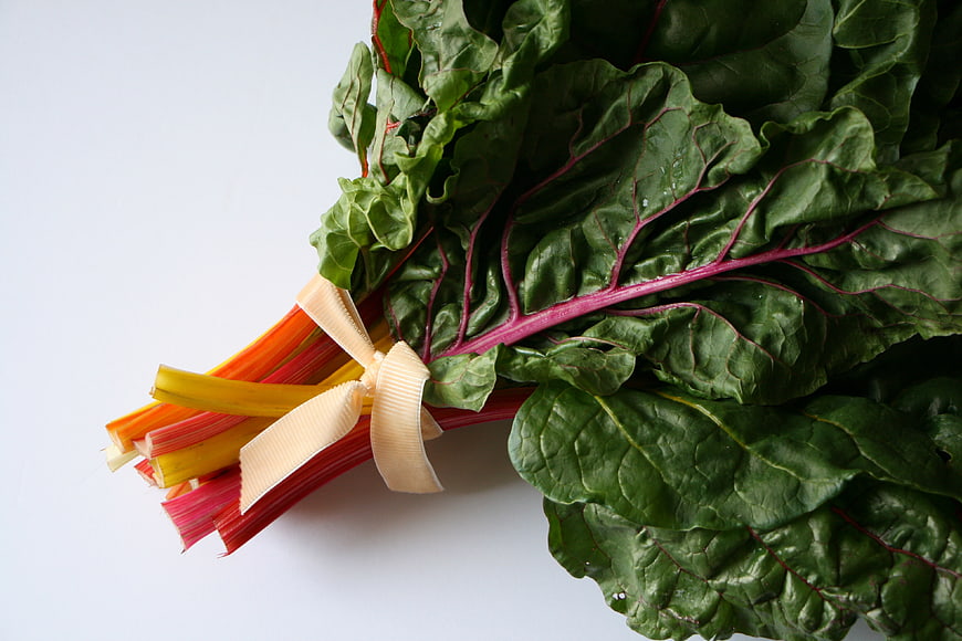 Fresh Rainbow Swiss Chard with Ribbon on White Background