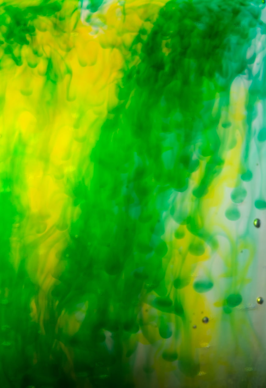 Abstract Green and Yellow Ink Swirling in Water
