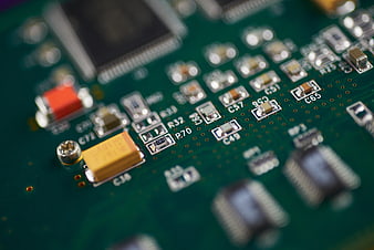 Macro shot of green circuit board with electronic components