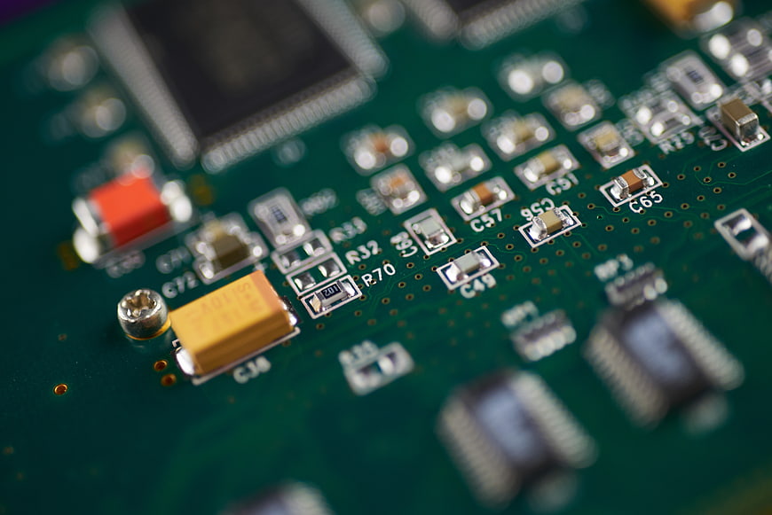 Macro shot of green circuit board with electronic components