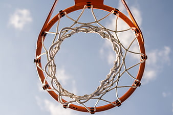 Low angle view of basketball hoop and net against blue sky