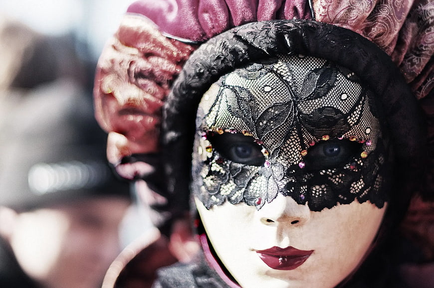 Close-up of woman wearing ornate black lace masquerade mask