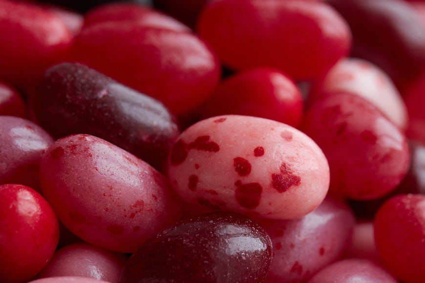 Close-up of colorful jelly beans with red and pink speckles