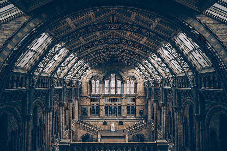 Grand Victorian Hall Interior with Arched Glass Roof and Staircase