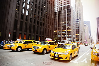 Yellow taxis lined up on busy New York City street
