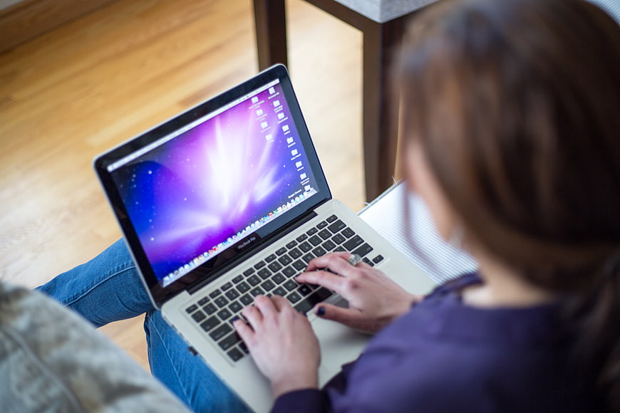 Woman Typing on Laptop in Casual Home Office Setting