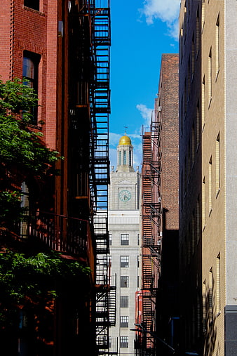 Urban Alleyway Framing Historic Clock Tower with Golden Dome
