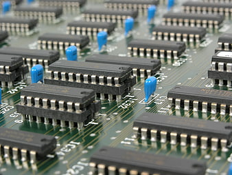 Close-up of electronic circuit board with microchips and capacitors