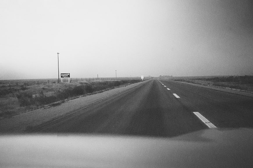 Vintage black and white photo of a lonely highway road