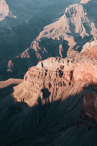 Sunlit Canyon Landscape with Dramatic Shadows and Rock Formations