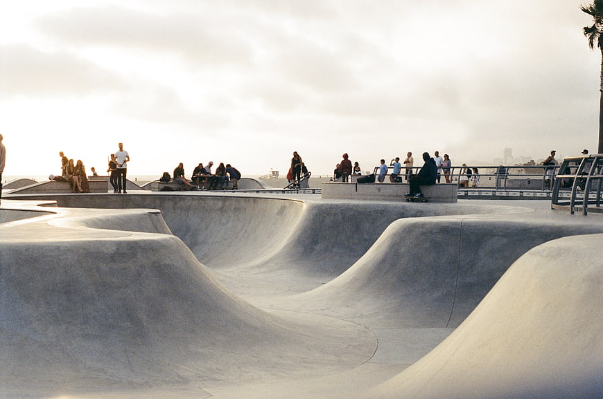 Skateboarders at Concrete Bowl Park at Sunset