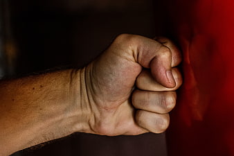 Close-up of clenched fist against red background