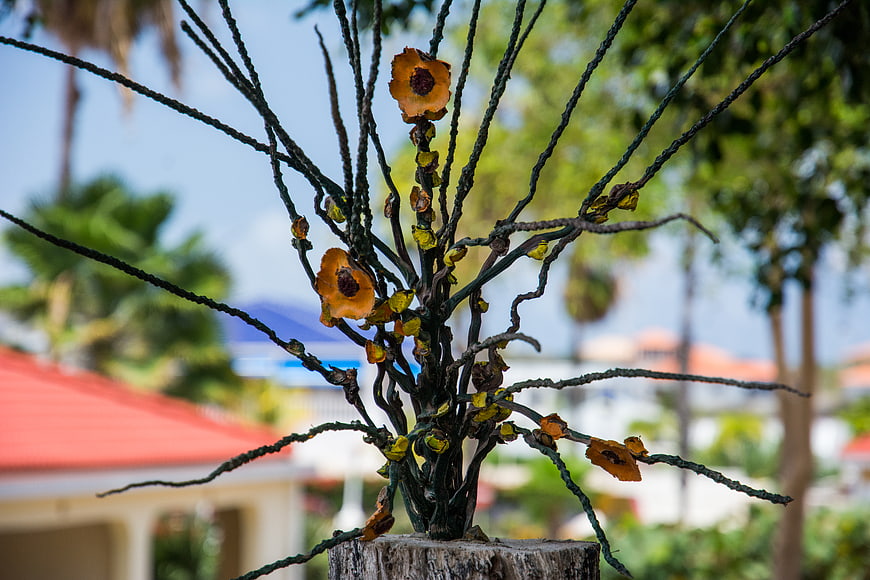 Artificial dried flower arrangement on wooden stump