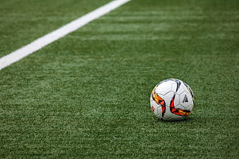 White Adidas Soccer Ball on Green Artificial Turf Field