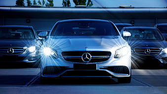 Front view of silver Mercedes-Benz with bright headlights