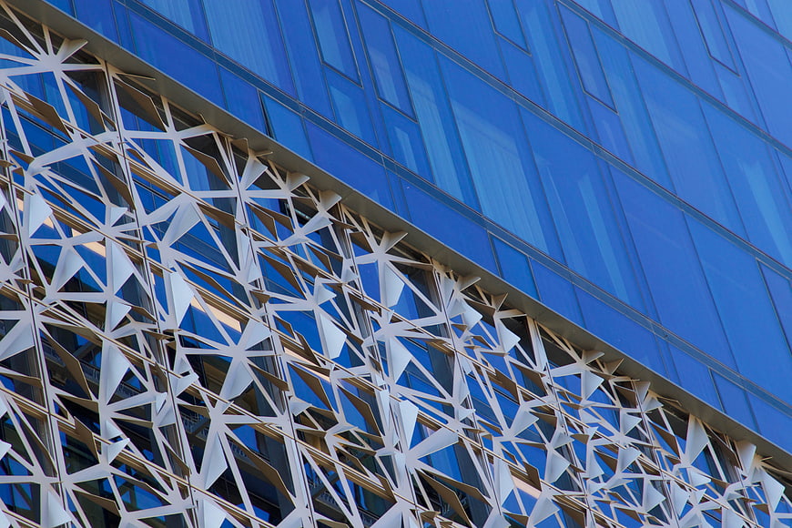 Modern Blue Glass Building with Geometric White Facade