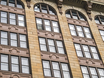 Ornate Beige Stone Building Facade with Arched Windows