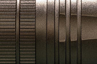 Close-up of black textured metal surface with industrial pattern