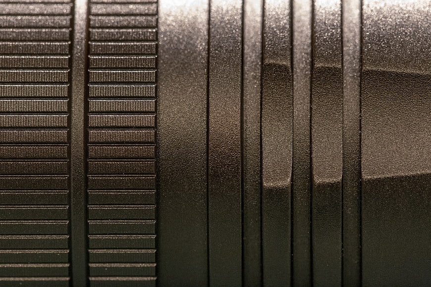 Close-up of black textured metal surface with industrial pattern