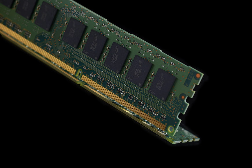 Close-up of green computer RAM module on black background