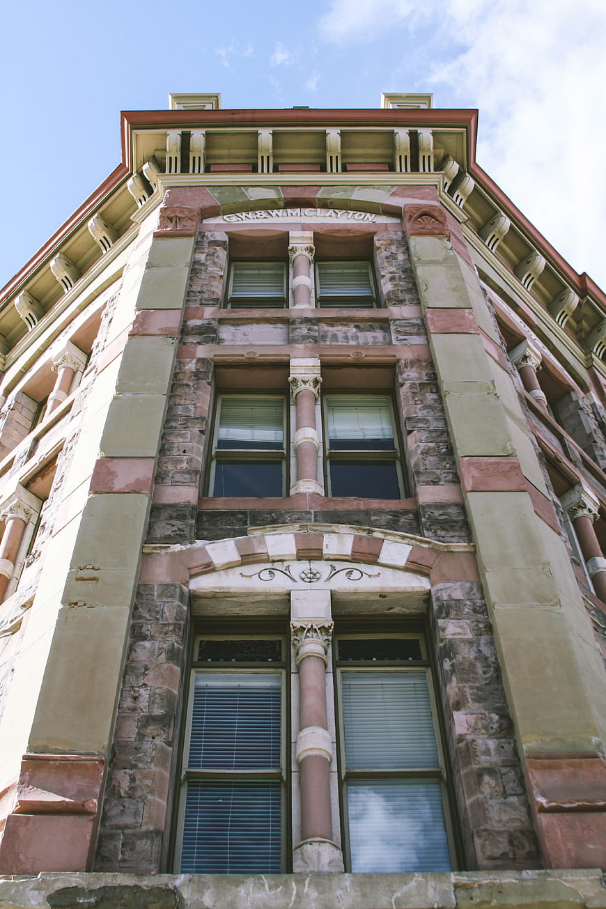 Low angle view of historic stone building facade with ornate details