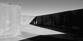 Minimalist black and white concrete architecture with dramatic shadows