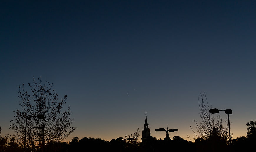 Silhouette of Church Spire and Trees Against Twilight Sky