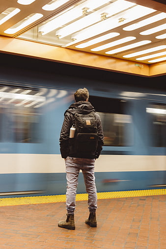 Man Waiting for Subway Train on Urban Platform