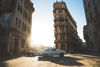 Vintage American car driving through Havana street corner