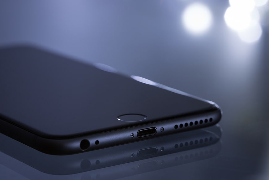 Close-up of black smartphone bottom edge with charging port