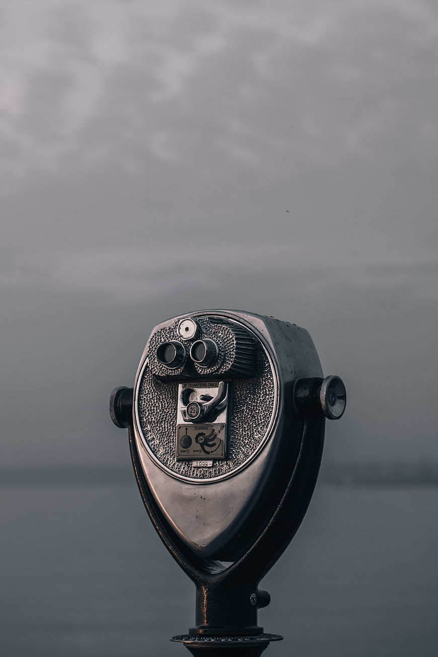 Vintage Coin-Operated Binoculars by the Water