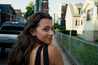 Portrait of smiling brunette woman on urban street