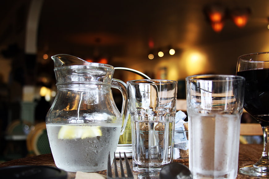 Water pitcher and glasses on restaurant table