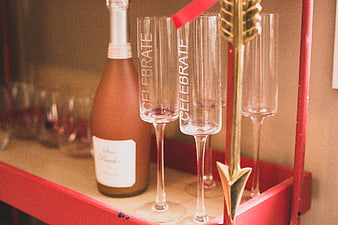 Champagne Flutes and Rosé Bottle on Red Bar Cart