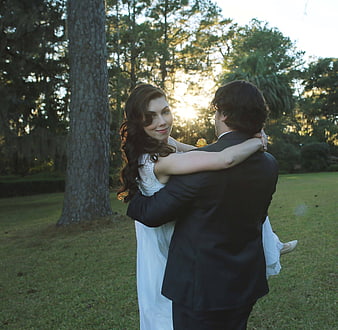 Bride and Groom Hugging in Backlit Forest at Sunset