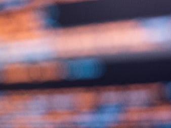 Abstract Blurred Background with Orange and Blue Light Streaks
