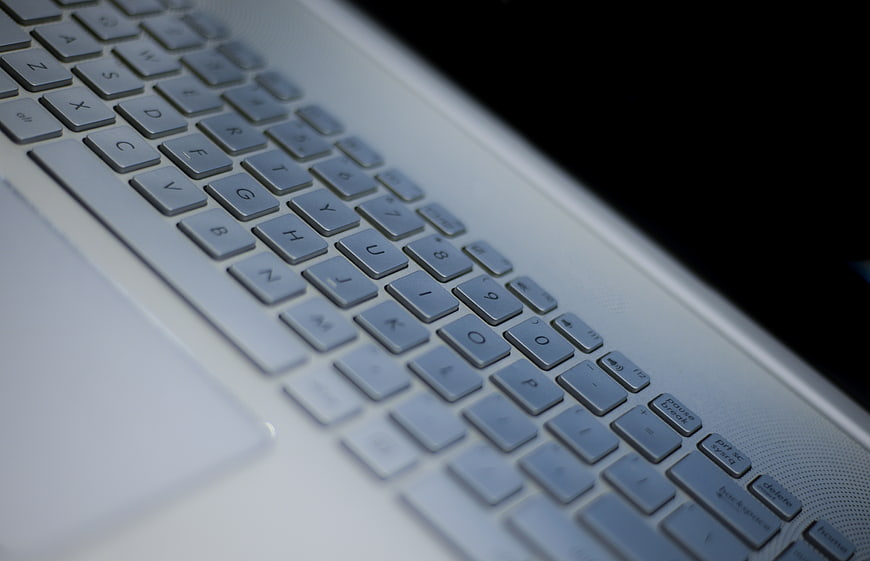 Close-up of silver laptop keyboard with shallow depth of field