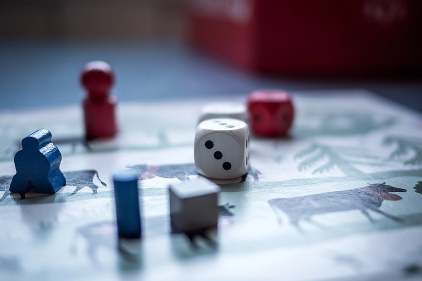 Close-up of wooden game pieces and dice on a board