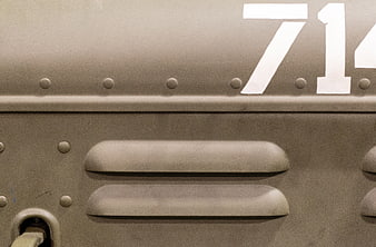 Close-up of vintage military tank armor with rivets and number 71